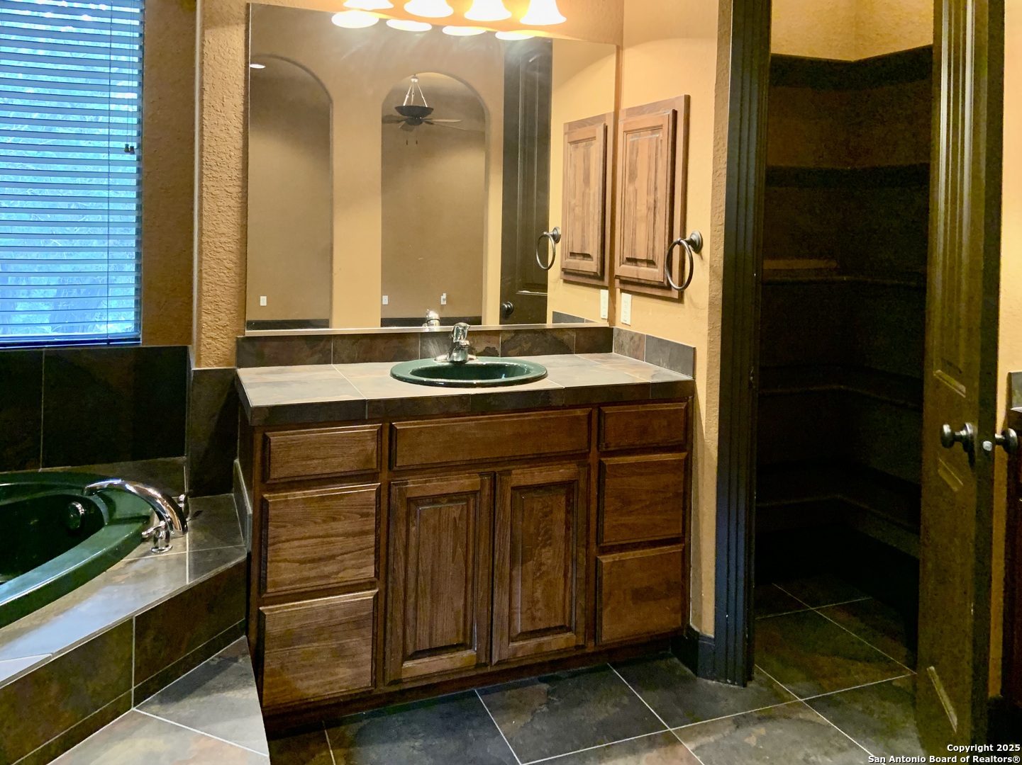 19940 Scenic Loop Road San Antonio, TX 78255 - Photo 10 of 34 a bathroom with a sink and a mirror