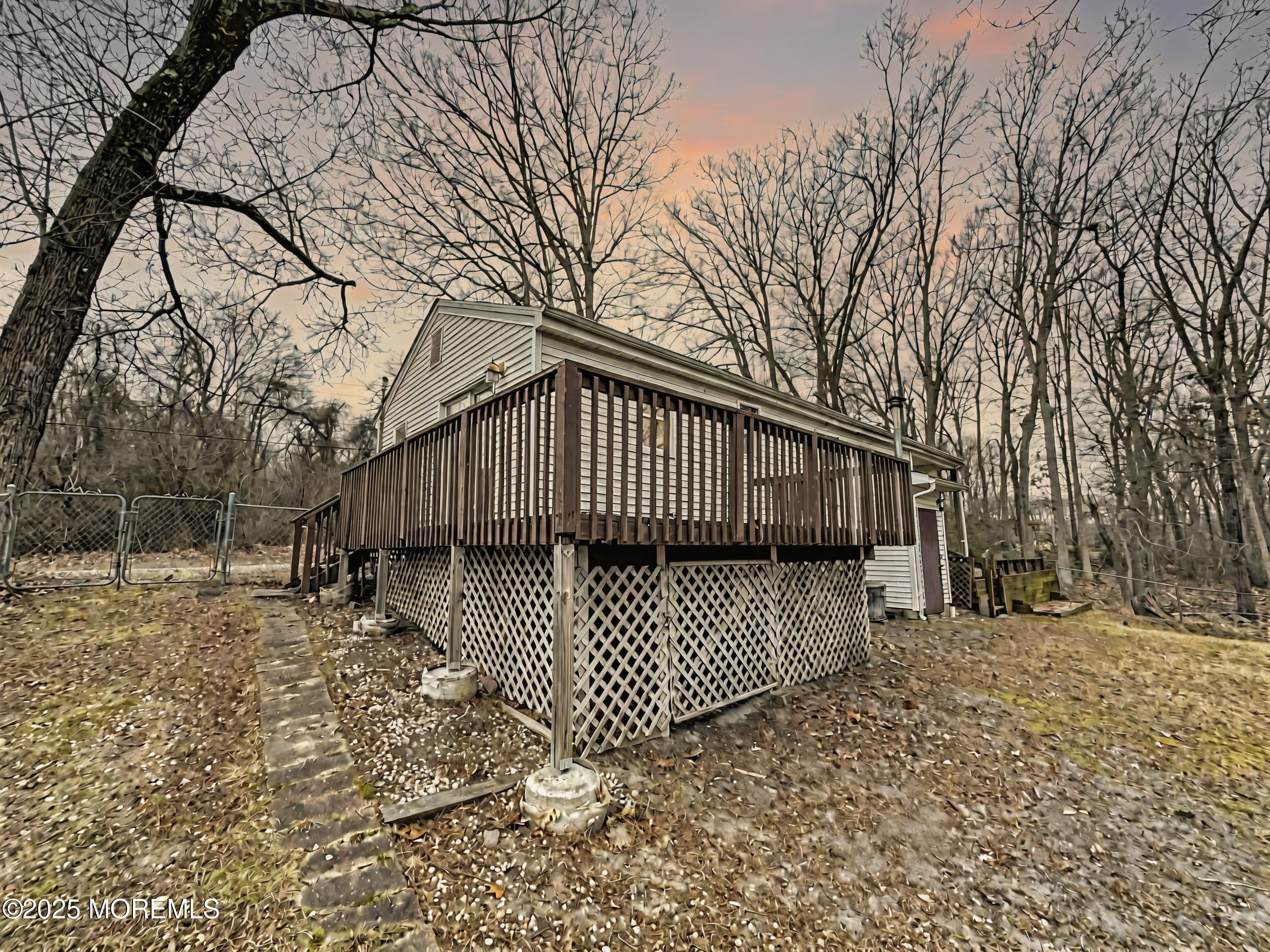 198 Lemon Road Farmingdale, NJ 07727 - Photo 2 of 13 a view of a yard with wooden fence and trees