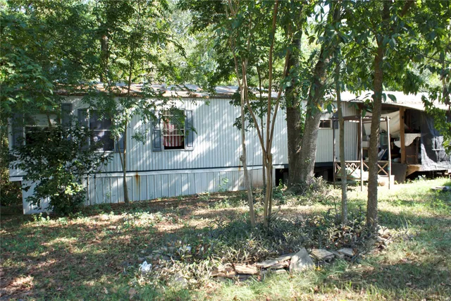 an aerial view of a house with yard