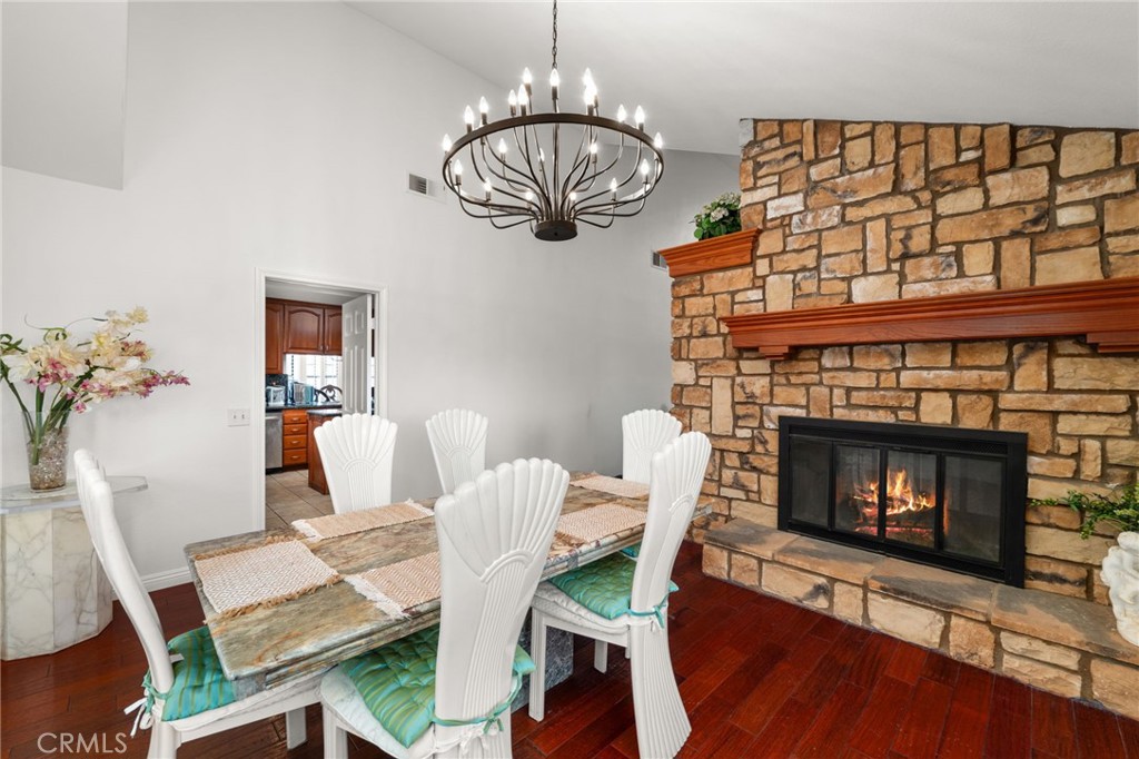12732 Arena Drive Rancho Cucamonga, CA 91739 - Photo 23 of 61 a view of a dining room with furniture wooden floor and a fireplace