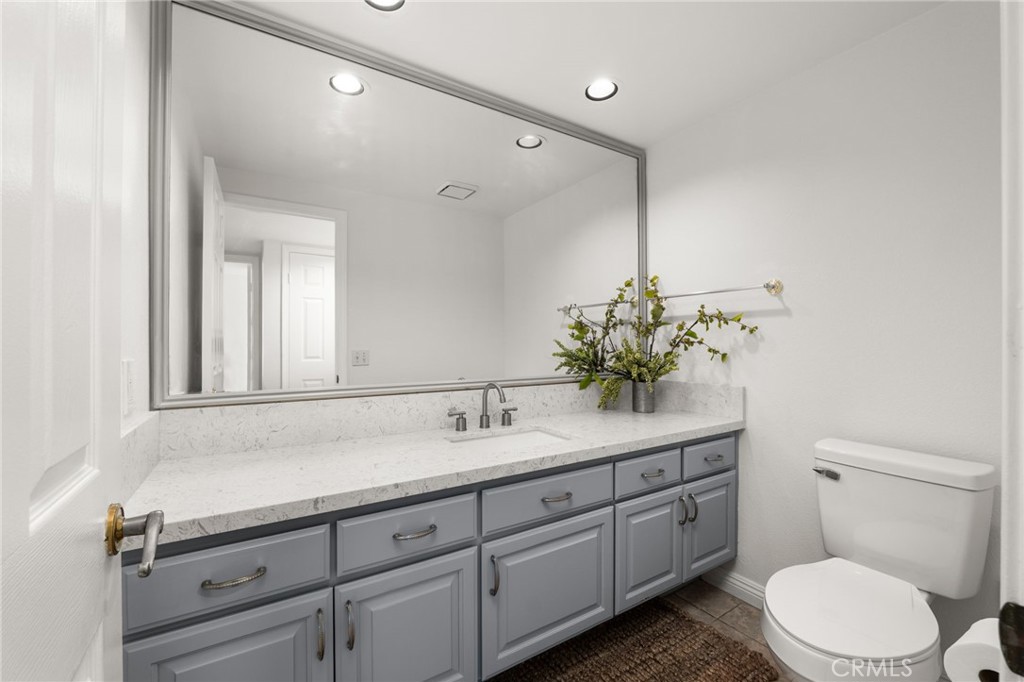 12732 Arena Drive Rancho Cucamonga, CA 91739 - Photo 24 of 61 a bathroom with a toilet sink and mirror