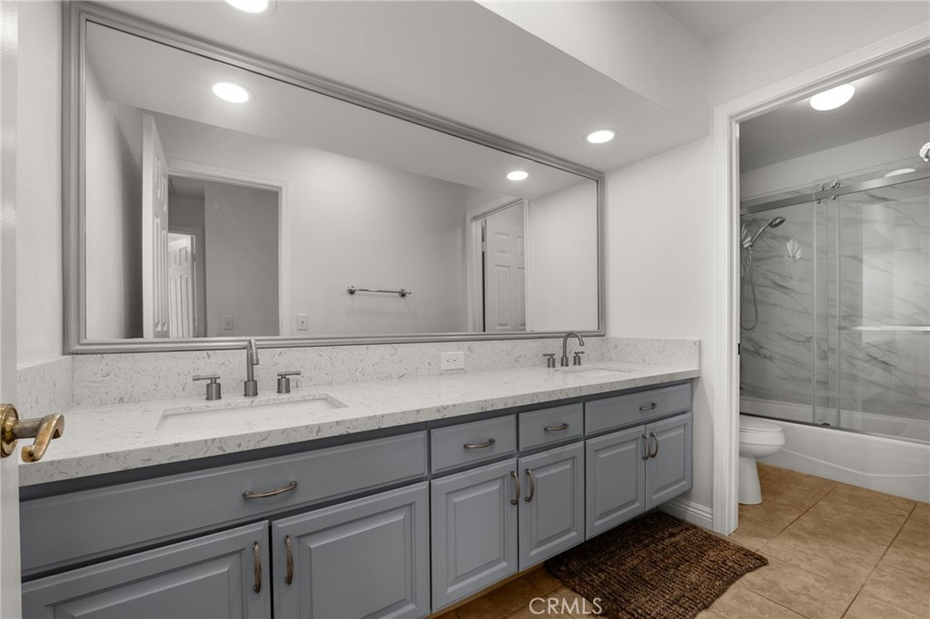 12732 Arena Drive Rancho Cucamonga, CA 91739 - Photo 38 of 61 a bathroom with double sink and a mirror