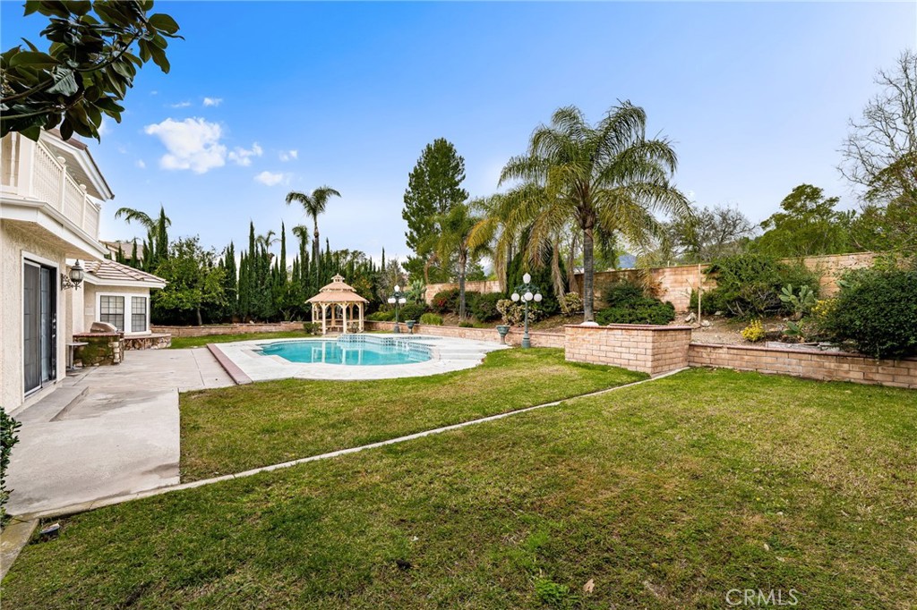 12732 Arena Drive Rancho Cucamonga, CA 91739 - Photo 40 of 61 a swimming pool with outdoor seating and yard
