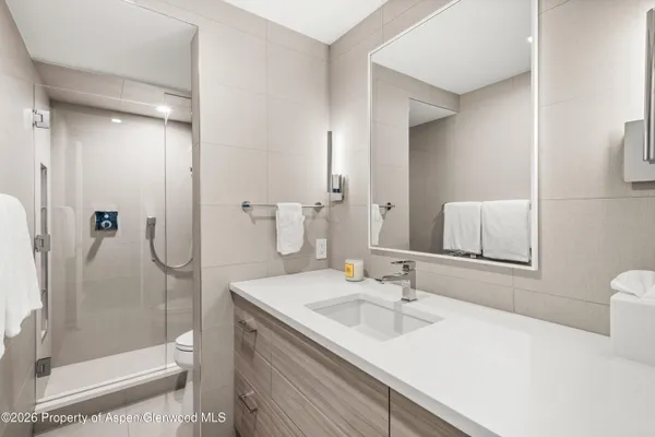 a living room with furniture a rug and wall painting