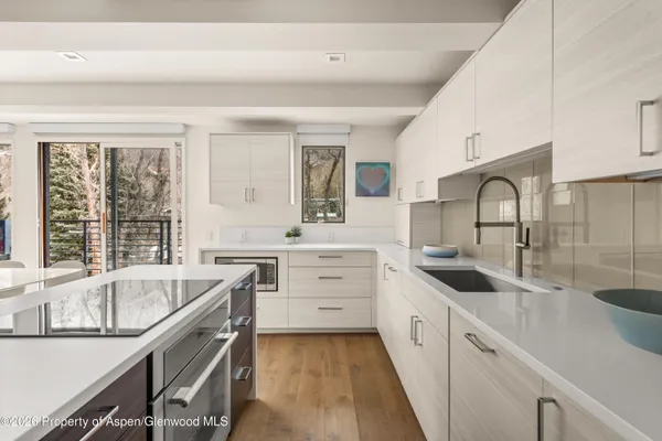 a kitchen with a sink stove and cabinets