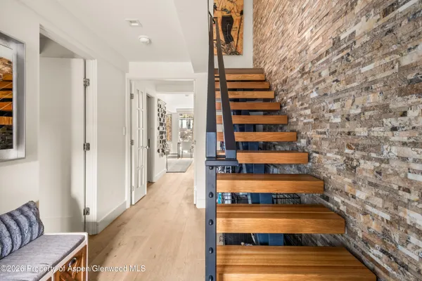 a view of a living room with furniture and stairs