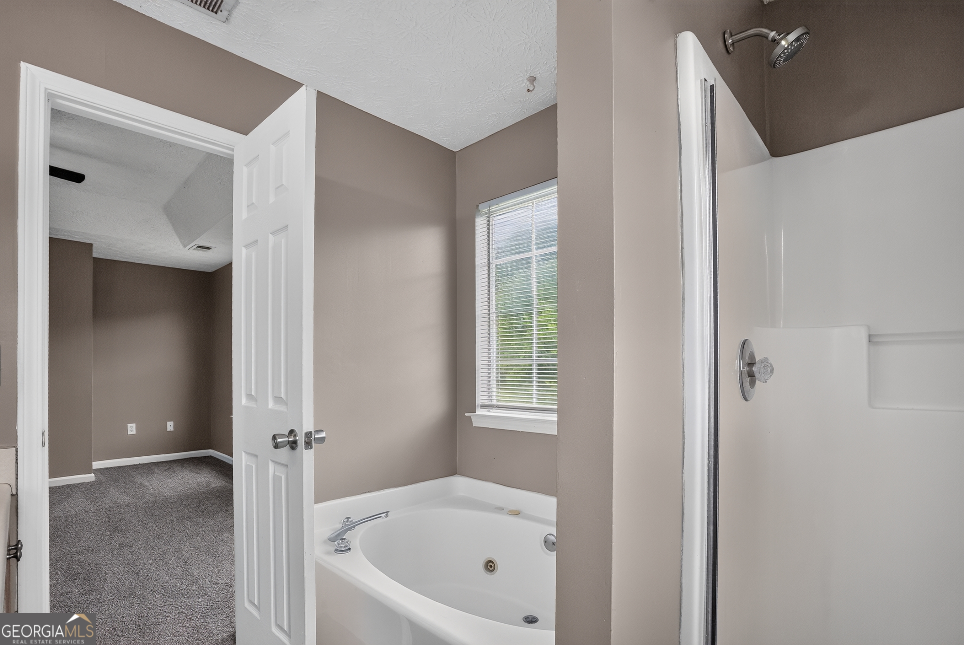 75 Linsley Way Covington, GA 30016 - Photo 34 of 48 a white bath tub sitting in a bathroom