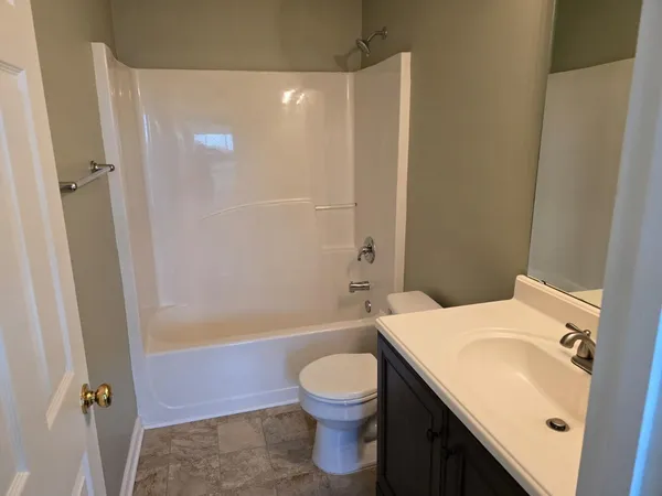 a bathroom with a sink a toilet and a shower