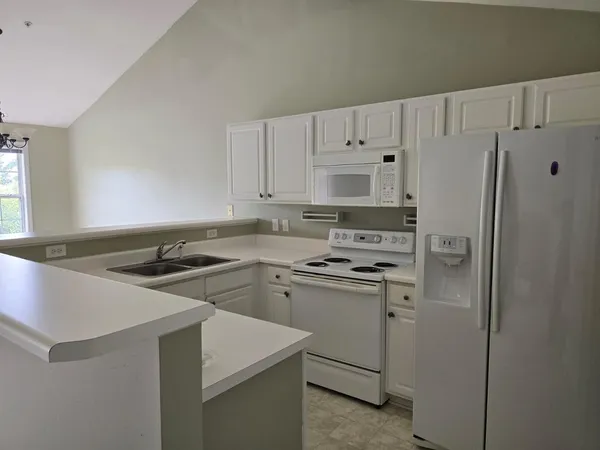 a kitchen with a stove a sink and a refrigerator