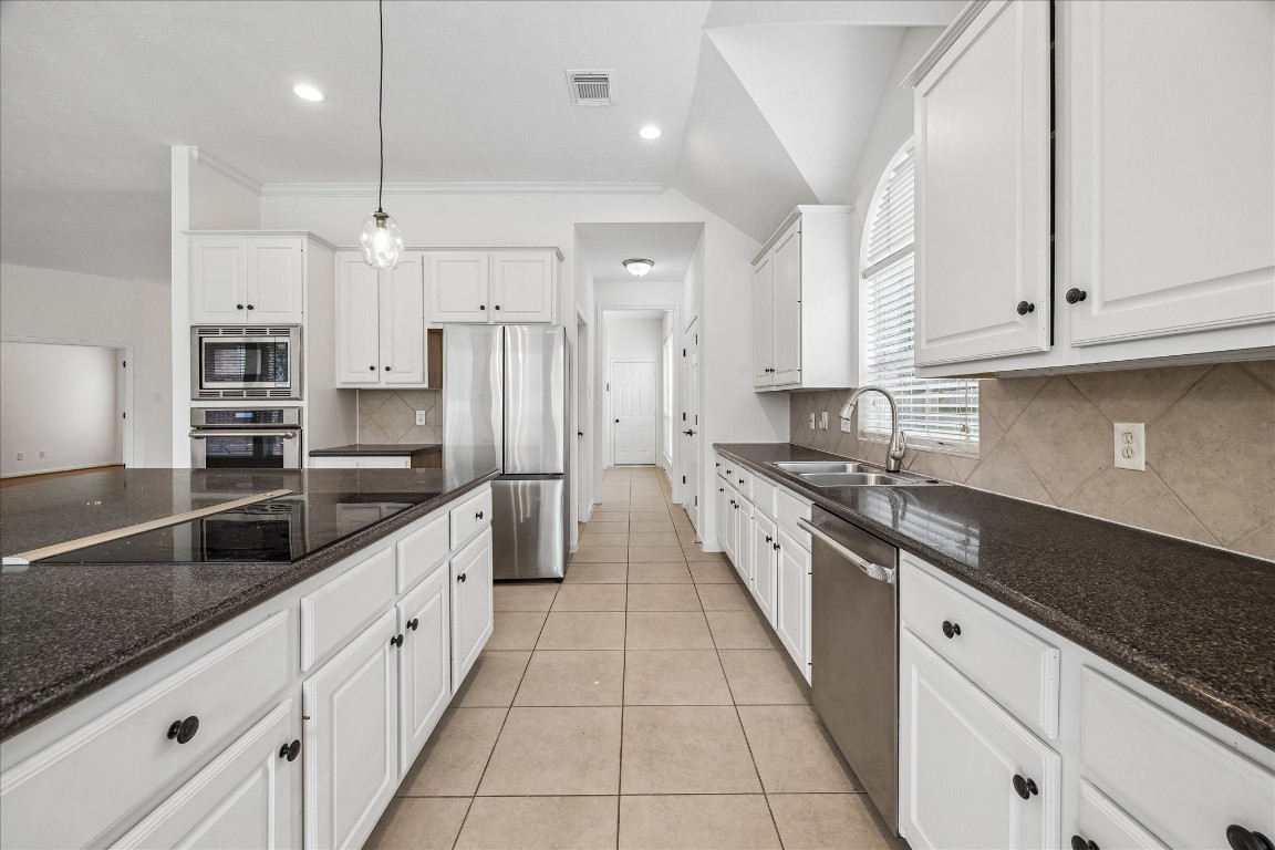 12507 Aliso Bend Lane Houston, TX 77041 - Photo 12 of 25 a large kitchen with stainless steel appliances granite countertop a sink a stove and a refrigerator