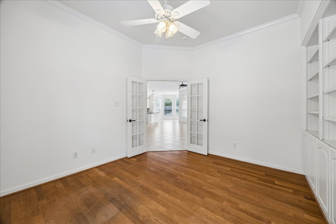 12507 Aliso Bend Lane Houston, TX 77041 - Photo 15 of 25 a view of empty room with wooden floor and ceiling fan