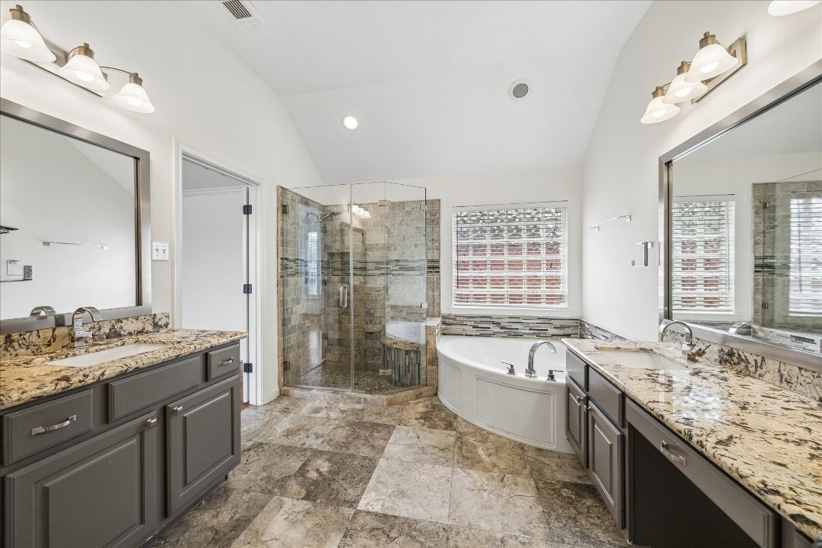 12507 Aliso Bend Lane Houston, TX 77041 - Photo 17 of 25 a spacious bathroom with a granite countertop tub sink and mirror