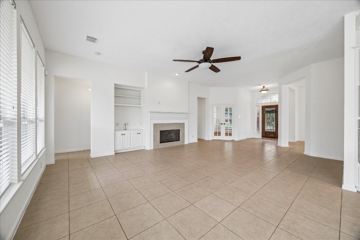 12507 Aliso Bend Lane Houston, TX 77041 - Photo 25 of 25 This light-filled sanctuary hosts high ceilings and a seamless open floor plan. The heart of the home is anchored by a cozy gas fireplace, perfect for relaxing in a bright, airy atmosphere designed for modern living.