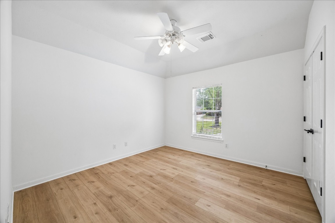12507 Aliso Bend Lane Houston, TX 77041 - Photo 20 of 25 wooden floor in an empty room with a window