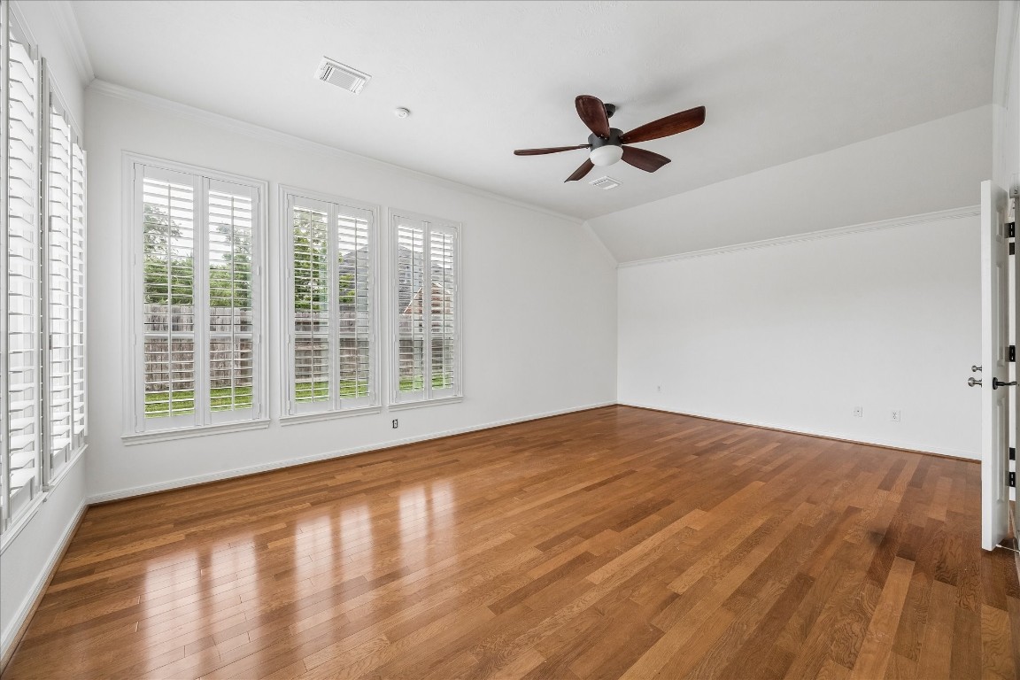12507 Aliso Bend Lane Houston, TX 77041 - Photo 3 of 25 a view of empty room with wooden floor and fan
