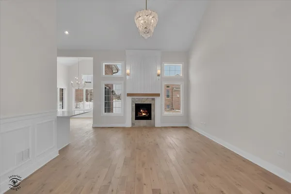 a view of an empty room with a fireplace and window