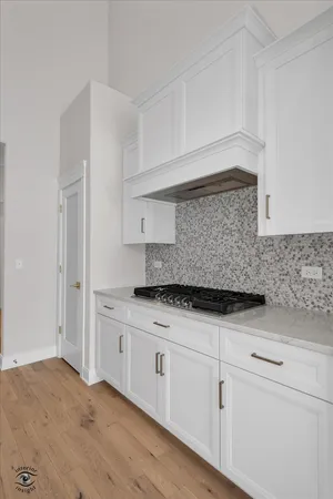 a kitchen with granite countertop white cabinets and white appliances