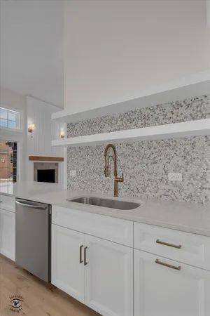 a kitchen with stainless steel appliances granite countertop a sink and a stove