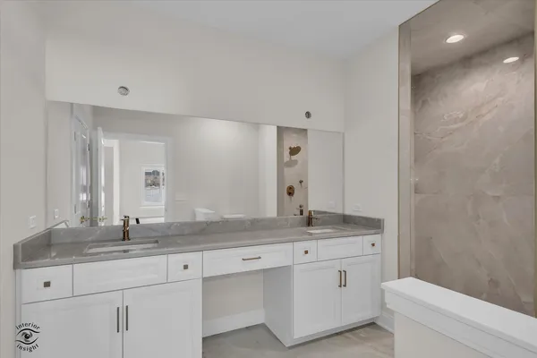 a bathroom with a granite countertop sink mirror and toilet