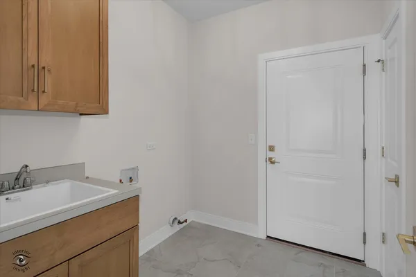 a room with a sink and cabinets