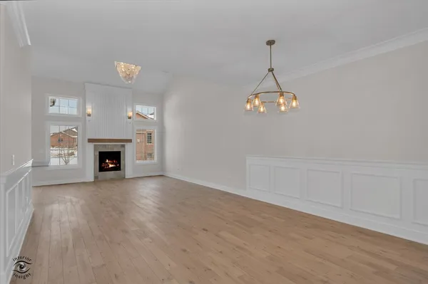 a view of a room with wooden floor and fireplace