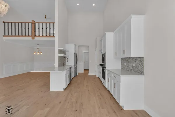 a view of a kitchen with cabinets and stainless steel appliances