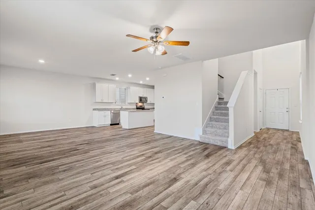 a view of kitchen view with wooden floor and cabinets