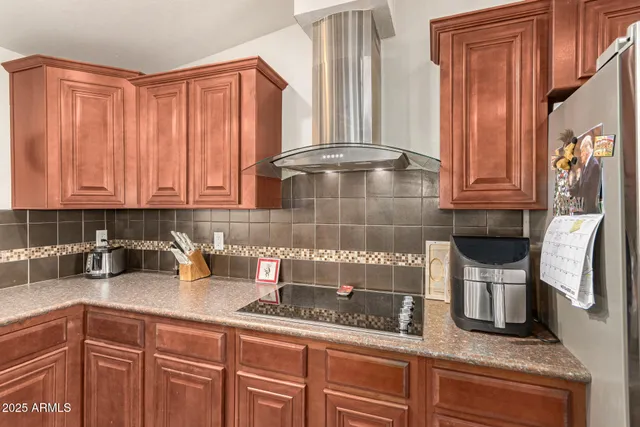 a kitchen with stainless steel appliances granite countertop a sink a stove and cabinets