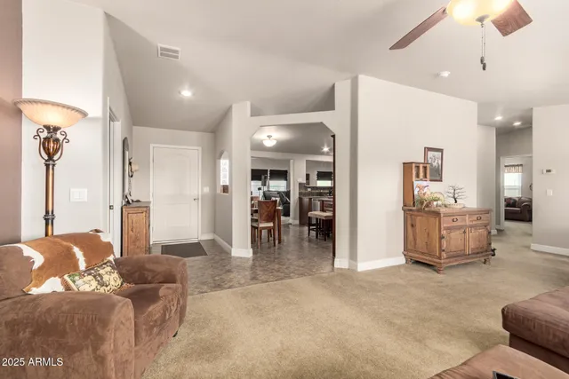 a living room with furniture and a dining table