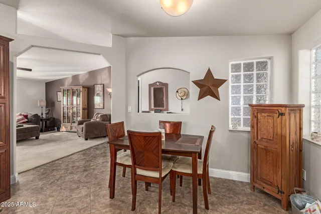 a view of a dining room with furniture and a window