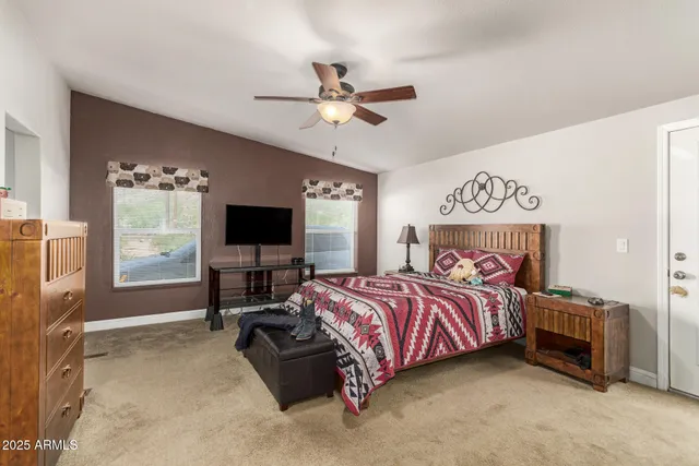 a bedroom with a bed and a flat screen tv