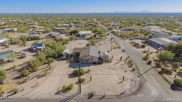 an aerial view of a house with a yard
