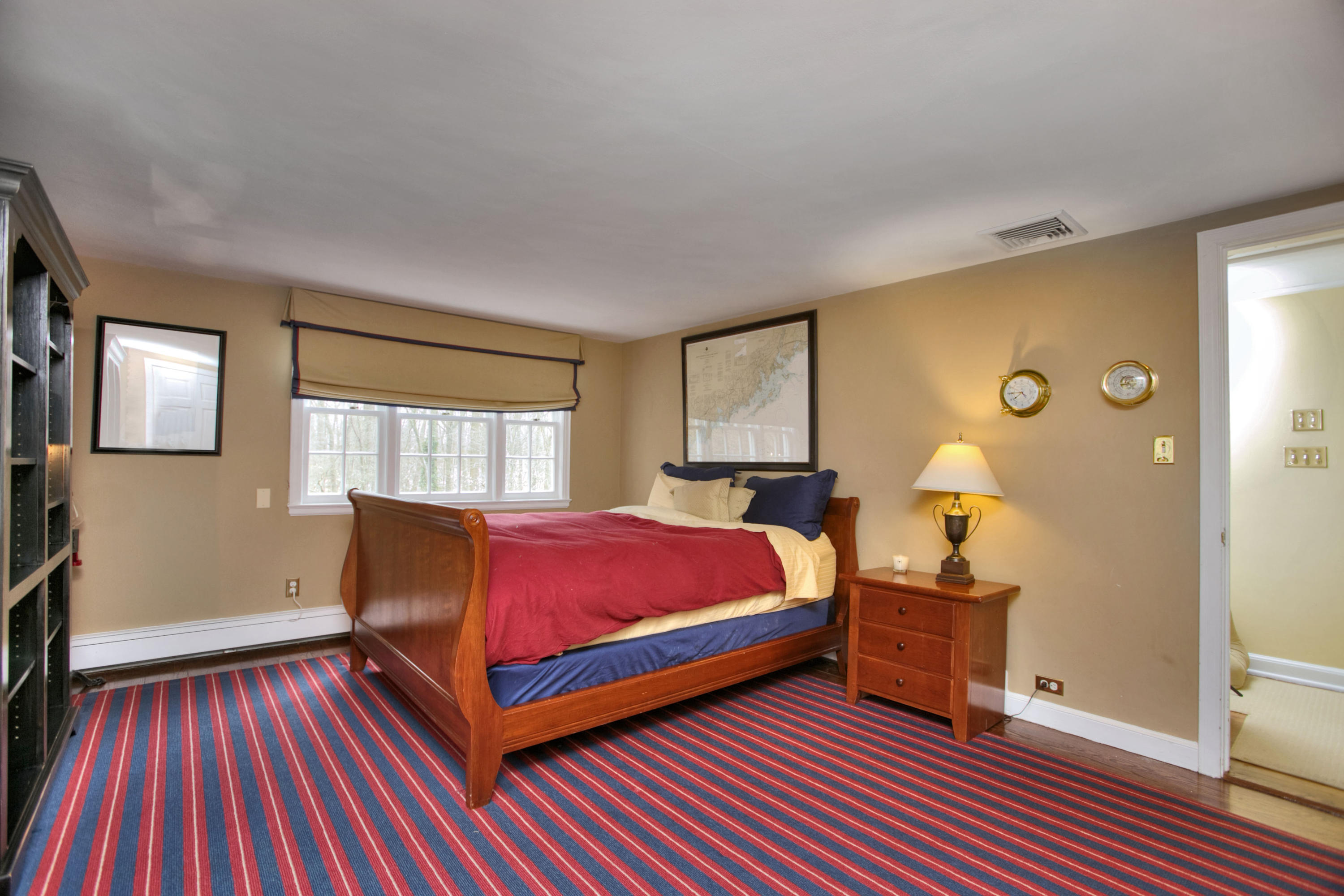 29 Stony Brook Road Darien, CT 06820 - Photo 18 of 24 a bedroom with a bed and wooden floor