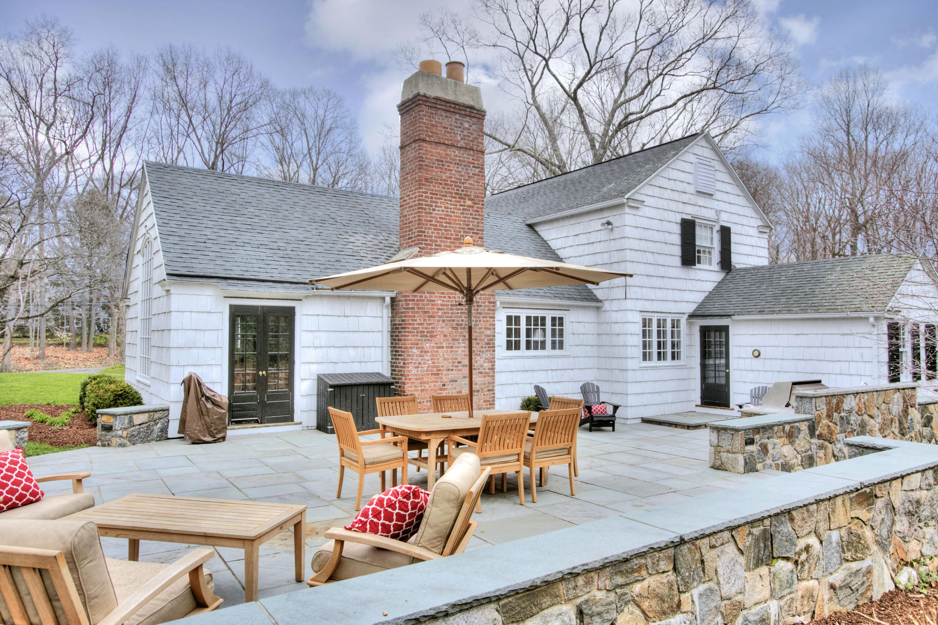 29 Stony Brook Road Darien, CT 06820 - Photo 20 of 24 deck with table and chairs under an umbrella