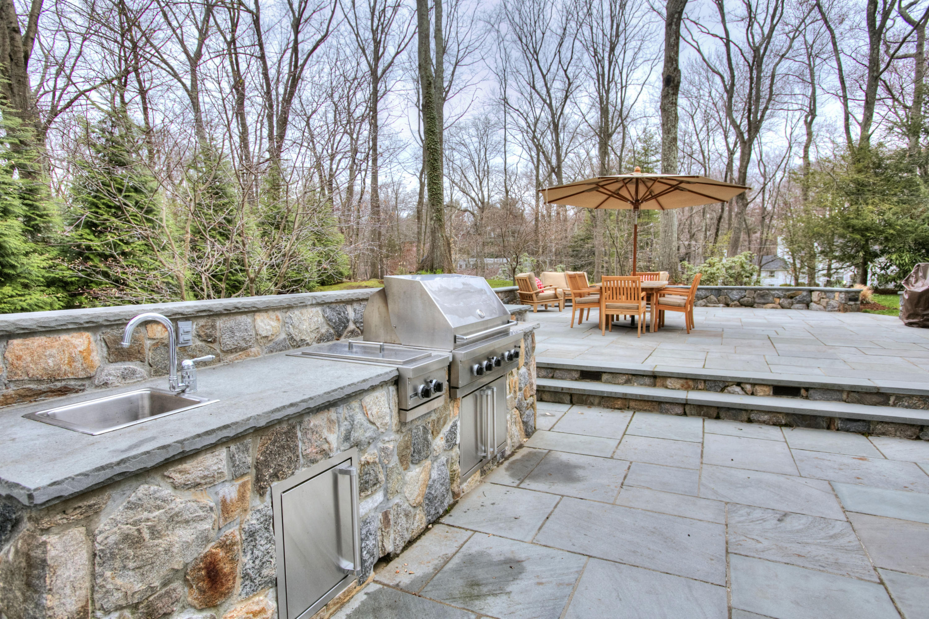 29 Stony Brook Road Darien, CT 06820 - Photo 22 of 24 a backyard of a house with table and chairs