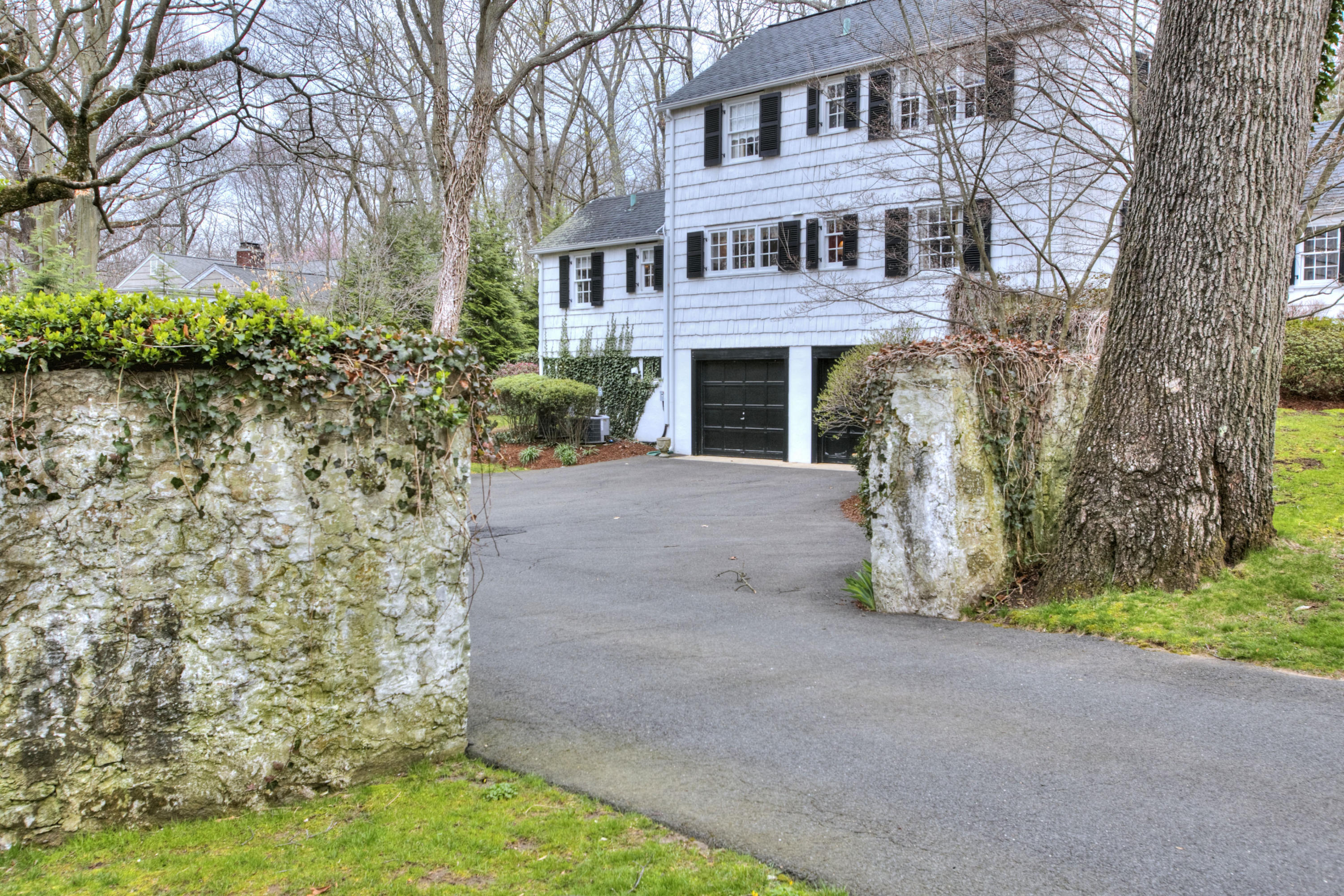 29 Stony Brook Road Darien, CT 06820 - Photo 24 of 24 a front view of a house with a yard and trees