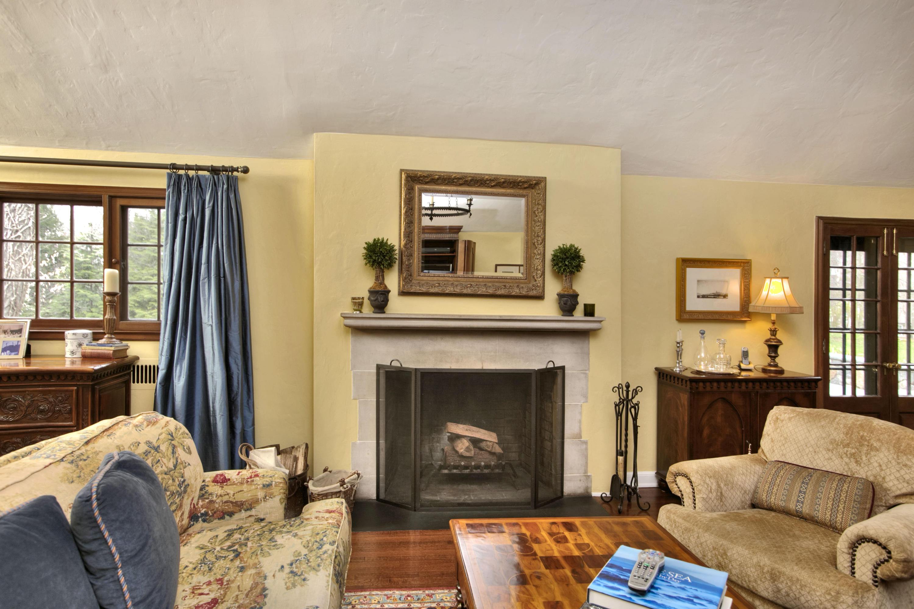 29 Stony Brook Road Darien, CT 06820 - Photo 4 of 24 a living room with furniture fireplace and a large window