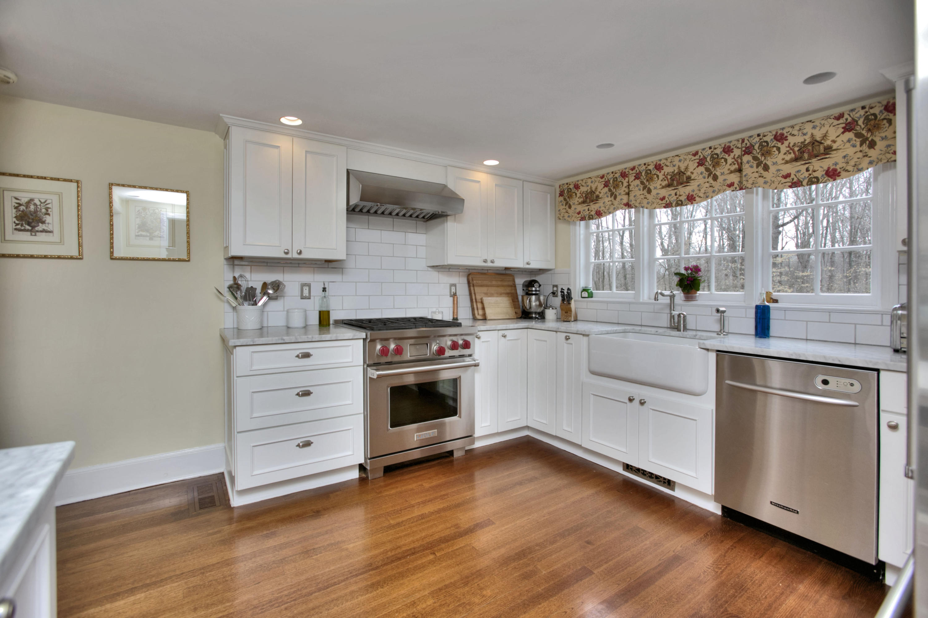 29 Stony Brook Road Darien, CT 06820 - Photo 9 of 24 a kitchen with stainless steel appliances a white stove top oven cabinets and a wooden floor