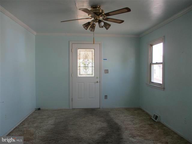 1717 Leslie Road Baltimore, MD 21222 - Photo 3 of 18 an empty room with windows and fan