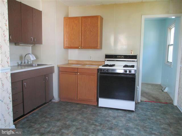 1717 Leslie Road Baltimore, MD 21222 - Photo 5 of 18 a kitchen with a stove and a sink