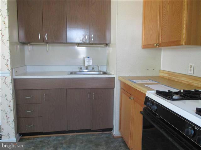 1717 Leslie Road Baltimore, MD 21222 - Photo 6 of 18 a kitchen with a sink and cabinets