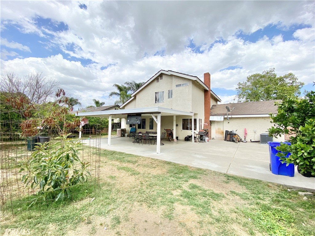 1444 North Sage Avenue Rialto, CA 92376 - Photo 6 of 22 a front view of a house with a yard table and chairs