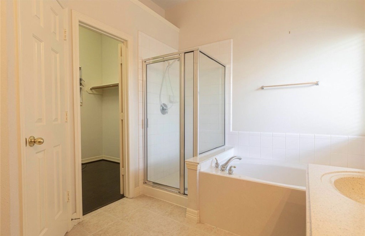 11518 Amber Canyon Drive Houston, TX 77095 - Photo 15 of 22 a bathroom with a bathtub and a shower