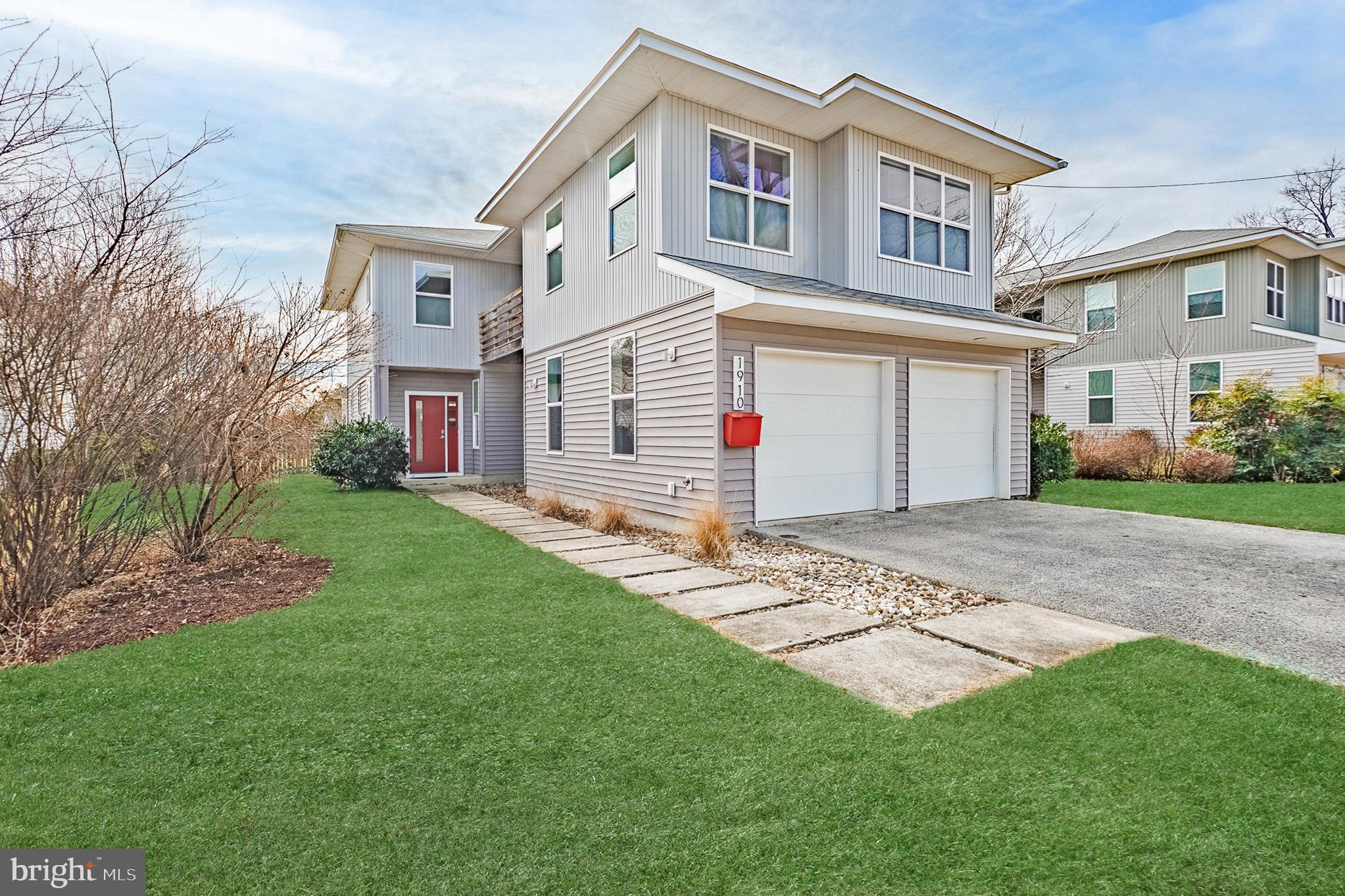 a front view of a house with a garden and plants