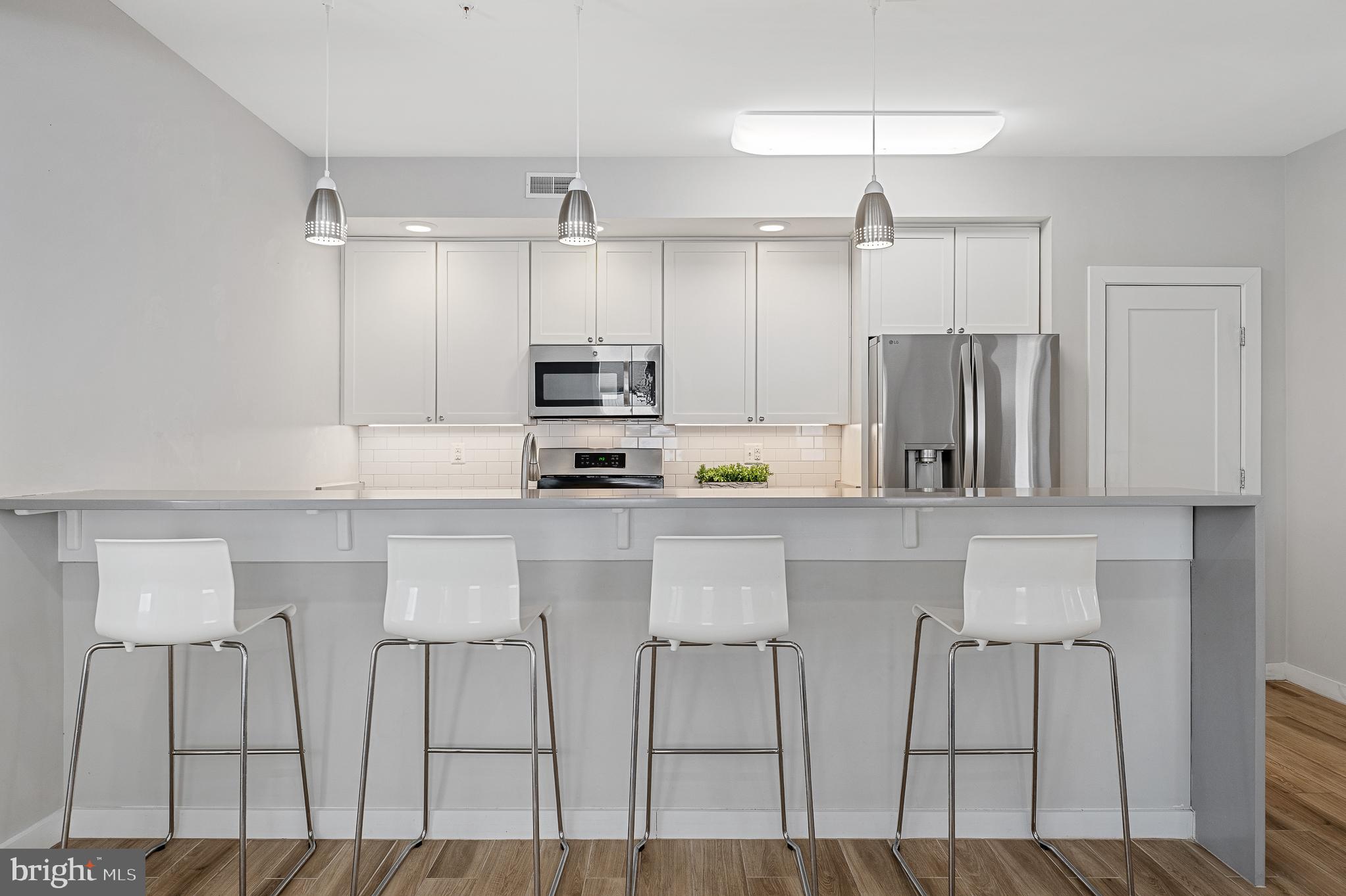 1910 Plyers Mill Road Silver Spring, MD 20902 - Photo 17 of 106 a kitchen with stainless steel appliances a refrigerator and cabinets