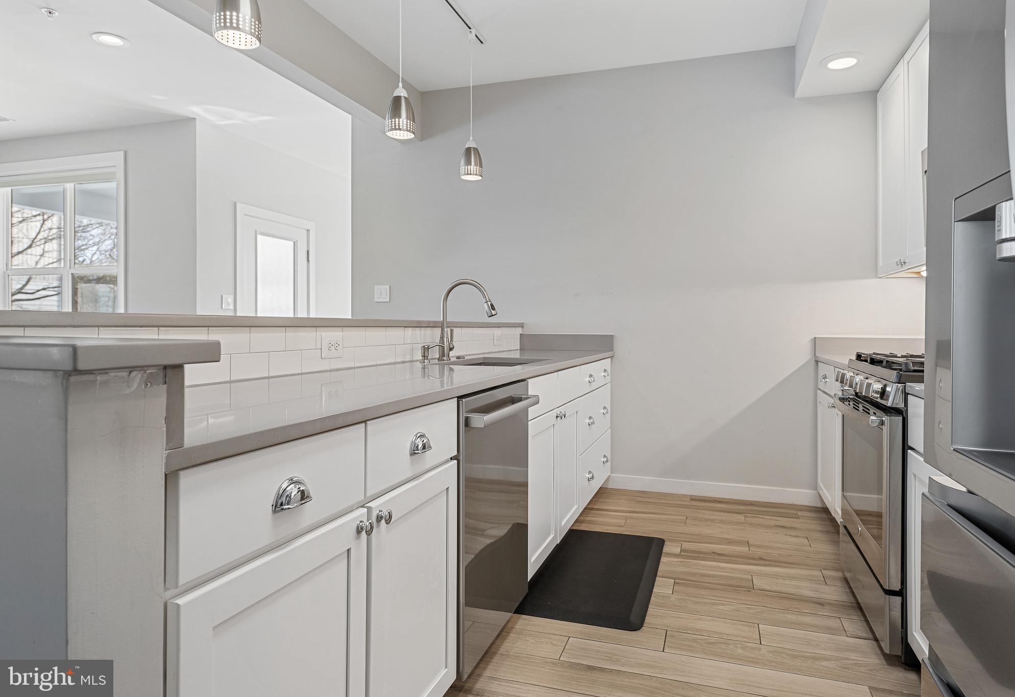 1910 Plyers Mill Road Silver Spring, MD 20902 - Photo 23 of 106 a kitchen with a sink stove and refrigerator