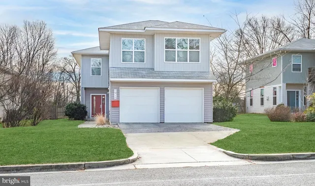 a front view of a house with a garden and plants
