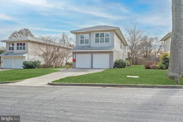 a view of a hallway with wooden floor and entryway