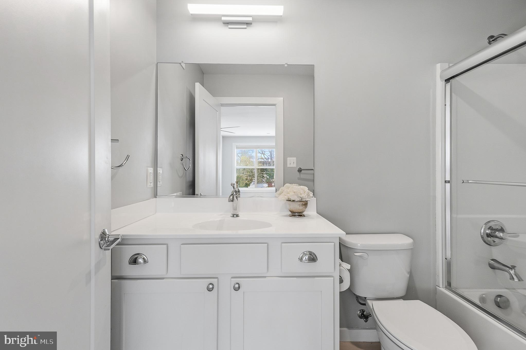 1910 Plyers Mill Road Silver Spring, MD 20902 - Photo 62 of 106 a bathroom with a sink toilet and mirror
