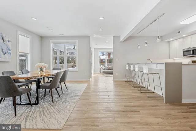 a view of a a dining room with furniture window and wooden floor